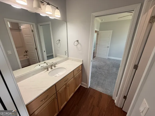 a bathroom with a tub sink and mirror