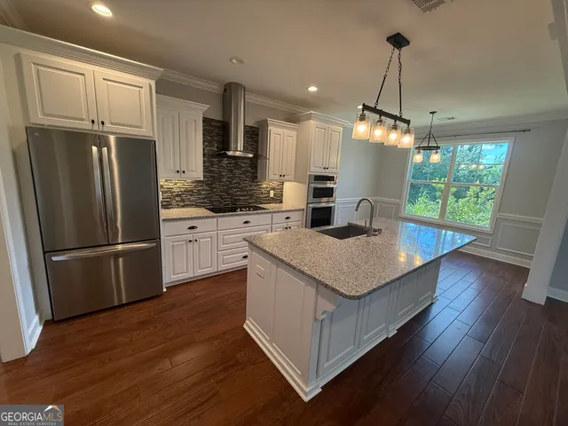 a view of walk in closet with wooden floor