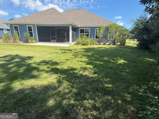 a view of a room with an empty space and large windows
