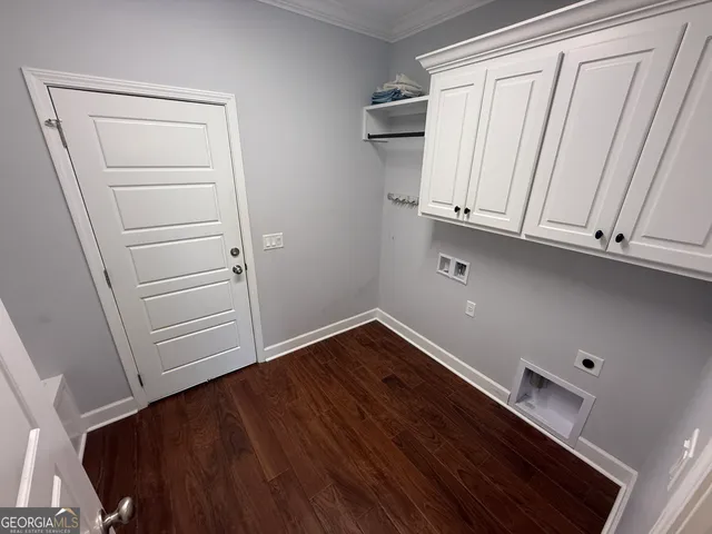 a view of storage and utility room with wooden floor