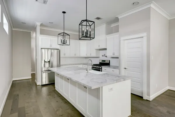 a kitchen with stainless steel appliances granite countertop a sink stove and refrigerator