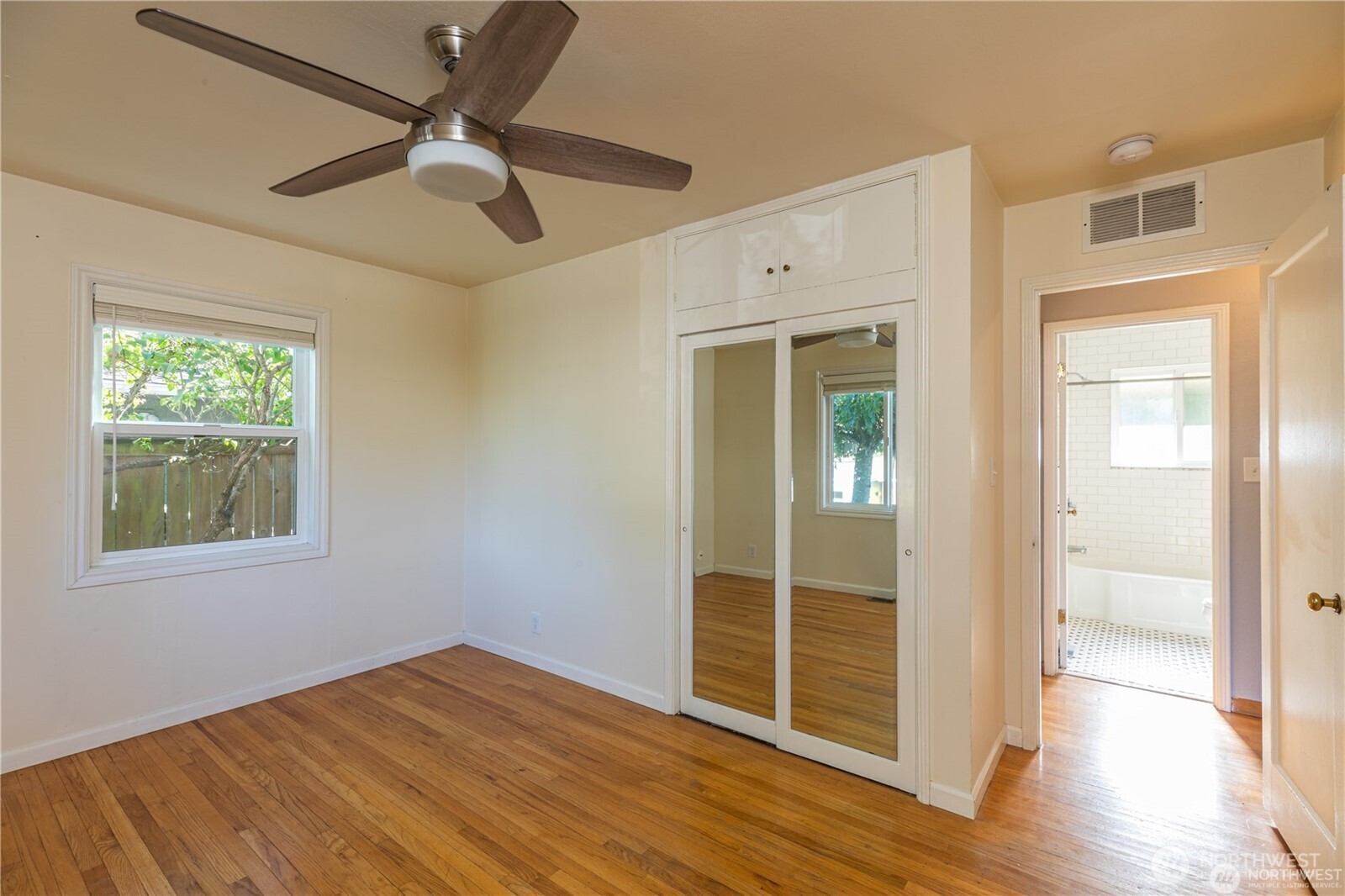 8601 36th Avenue Southwest Seattle, WA 98126 - Photo 17 of 28 a view of empty room with wooden floor and fan
