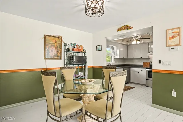 a view of a dining room with furniture and a kitchen view