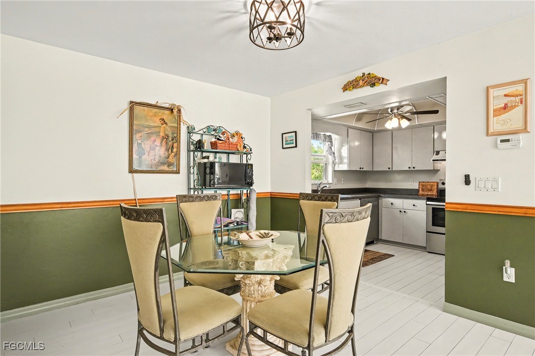 285 Dundee Road Fort Myers Beach, FL 33931 - Photo 13 of 42 a view of a dining room with furniture and a kitchen view