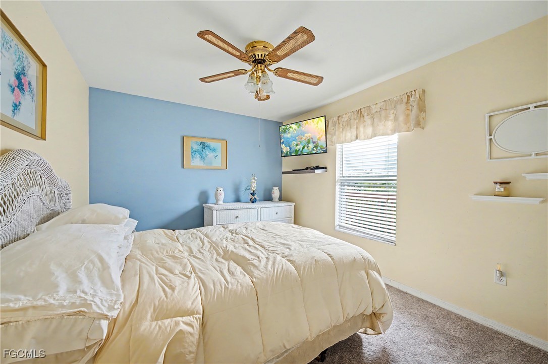 285 Dundee Road Fort Myers Beach, FL 33931 - Photo 15 of 42 a bedroom with a bed and window