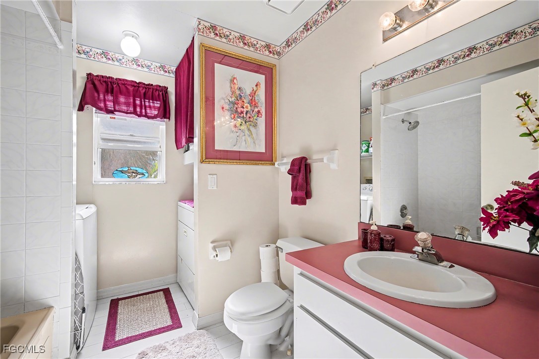 285 Dundee Road Fort Myers Beach, FL 33931 - Photo 16 of 42 a bathroom with a sink a toilet and a mirror