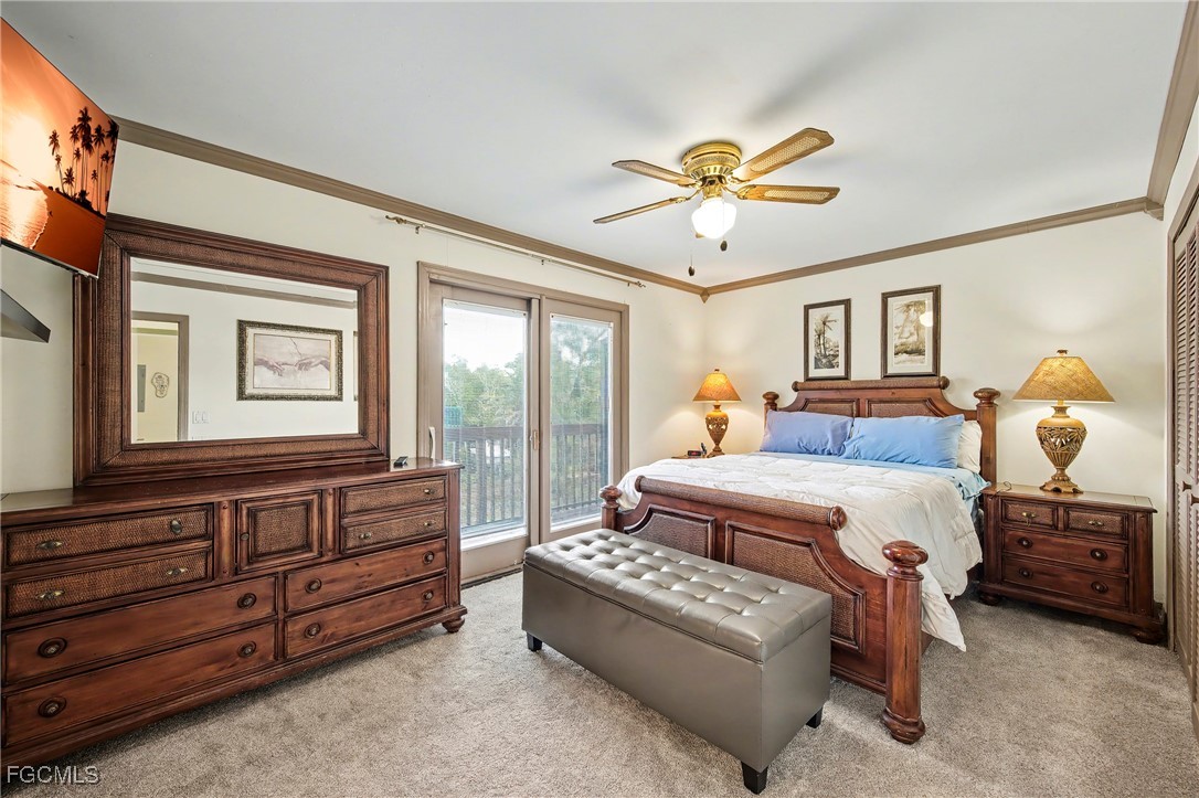 285 Dundee Road Fort Myers Beach, FL 33931 - Photo 17 of 42 a bedroom with a large bed and a chandelier