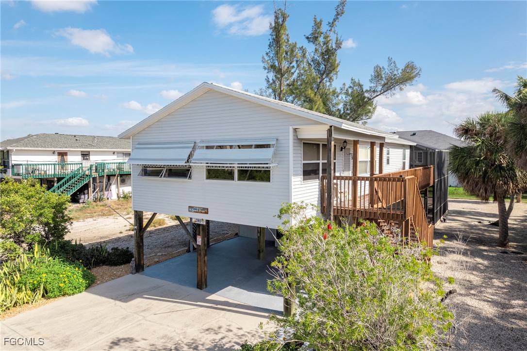 285 Dundee Road Fort Myers Beach, FL 33931 - Photo 2 of 42 a view of a house with backyard and sitting area