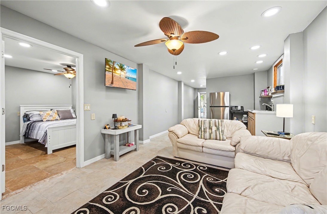 285 Dundee Road Fort Myers Beach, FL 33931 - Photo 26 of 42 a living room with furniture and a chandelier
