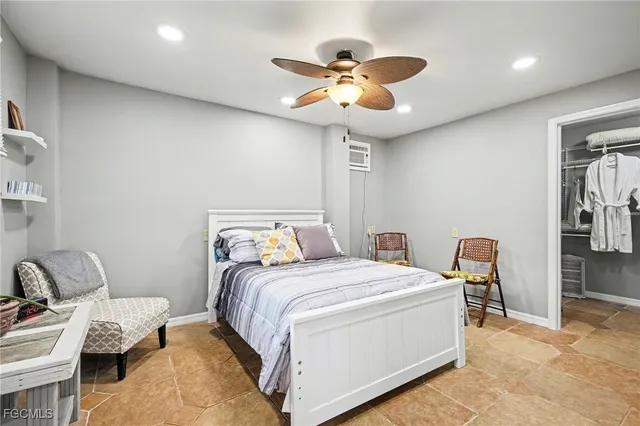 a bedroom with bed and a chandelier