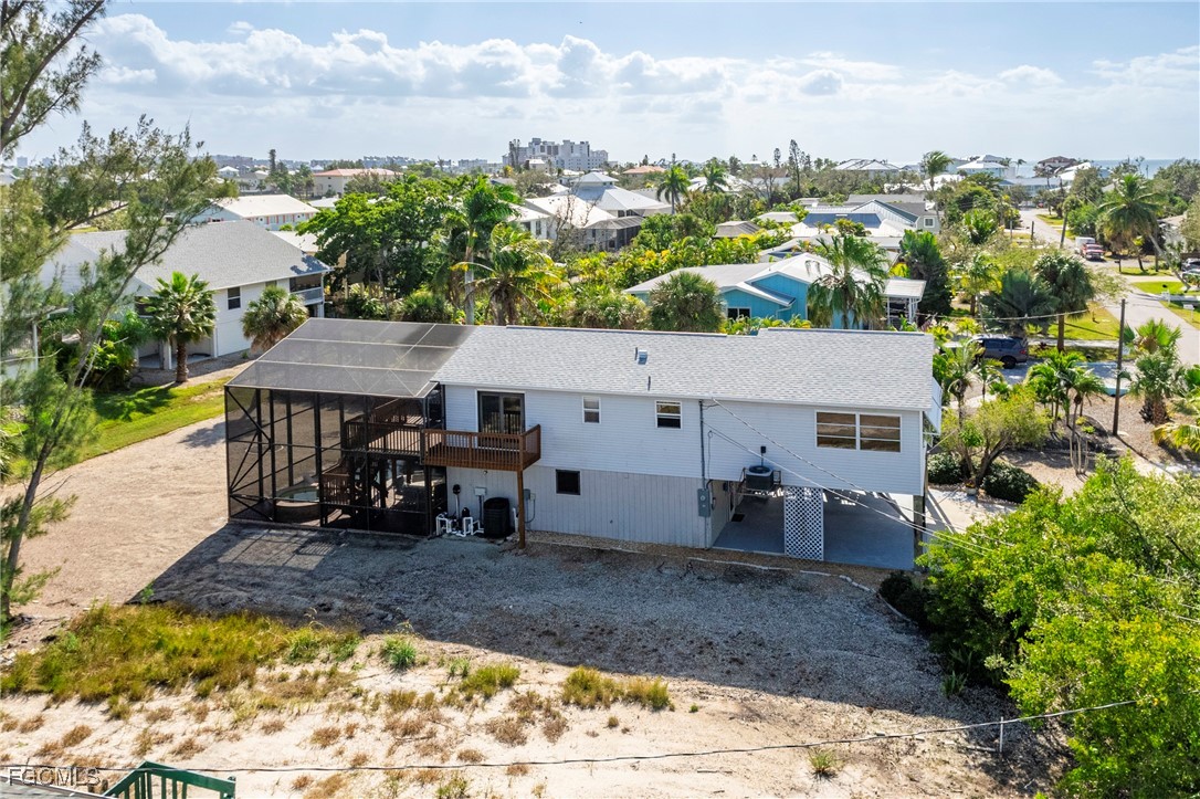 285 Dundee Road Fort Myers Beach, FL 33931 - Photo 3 of 42 an aerial view of a house with a yard and sitting area