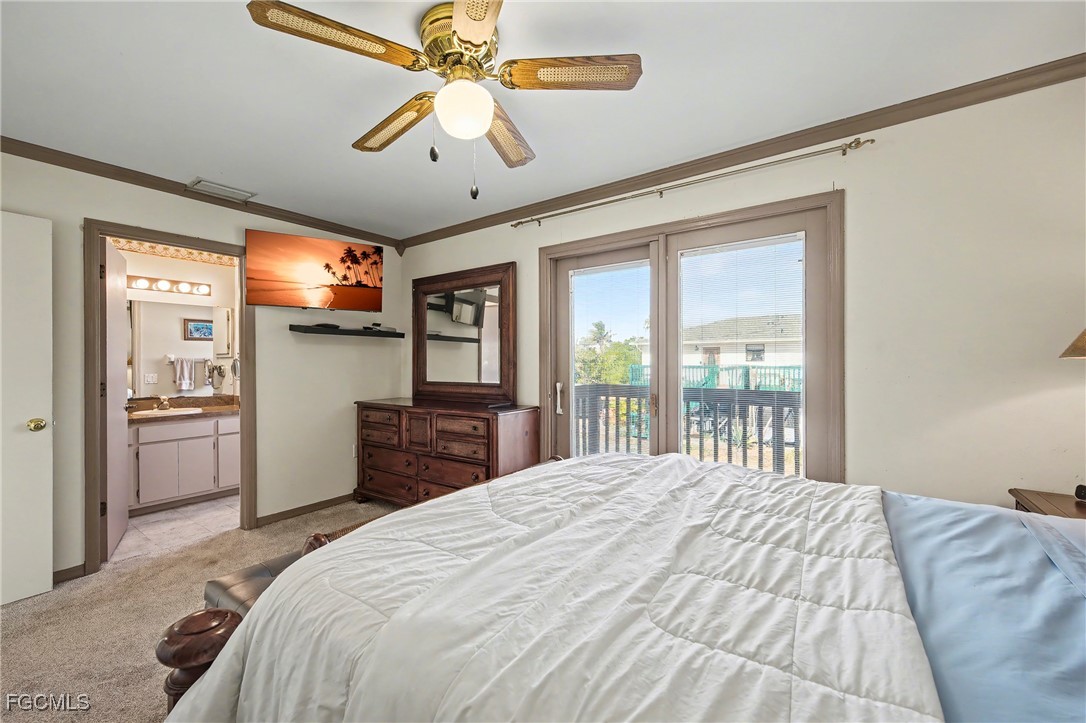 285 Dundee Road Fort Myers Beach, FL 33931 - Photo 41 of 42 a bedroom with a large bed and a flat tv screen