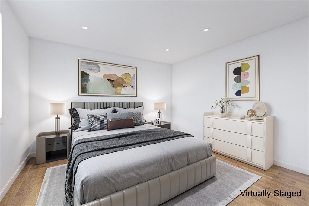 22 Deer Path, Unit 6 Maynard, MA 01754 - Photo 11 of 34 a bedroom with a bed and a painting on the wall