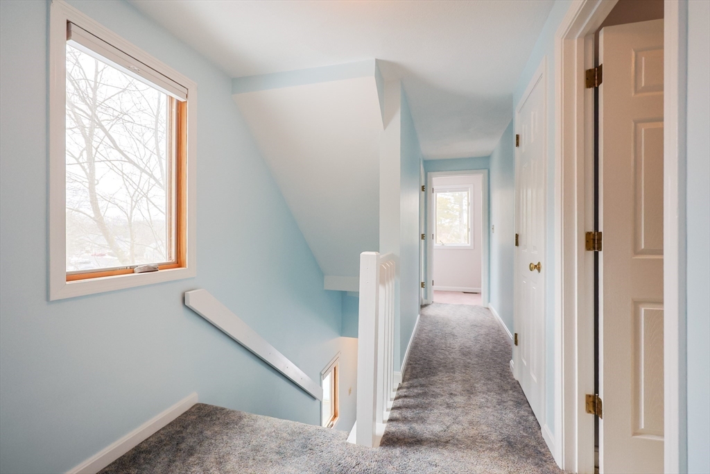 22 Deer Path, Unit 6 Maynard, MA 01754 - Photo 24 of 34 a view of a hallway with a window