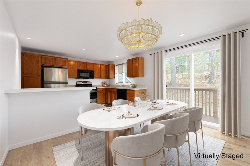 22 Deer Path, Unit 6 Maynard, MA 01754 - Photo 3 of 34 a view of a dining room with furniture window and outside view
