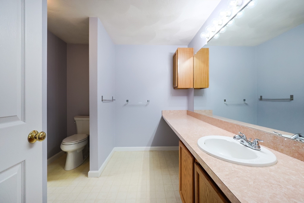 22 Deer Path, Unit 6 Maynard, MA 01754 - Photo 6 of 34 a bathroom with a sink toilet and mirror