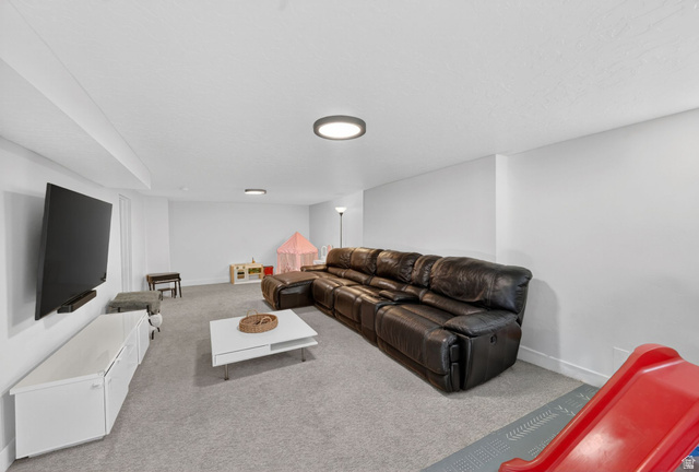 66 South 425 West Bountiful, UT 84010 - Photo 18 of 25 Spacious recreation room featuring light gray carpeting and white walls