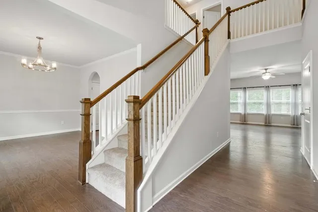 a view of staircase and living room with wooden floor