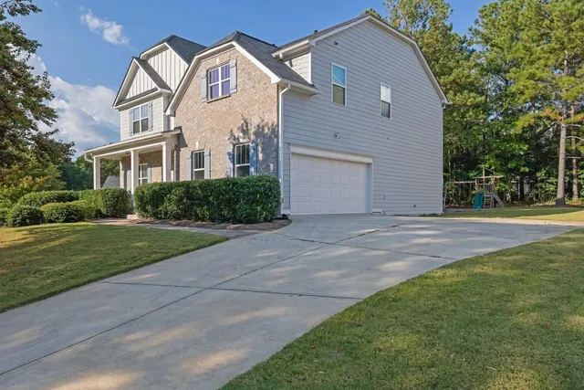 a view of a white house with a yard