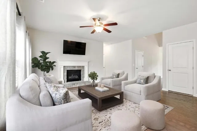 a living room with furniture and a fireplace