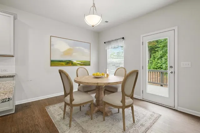 a view of a dining room with furniture window and wooden floor