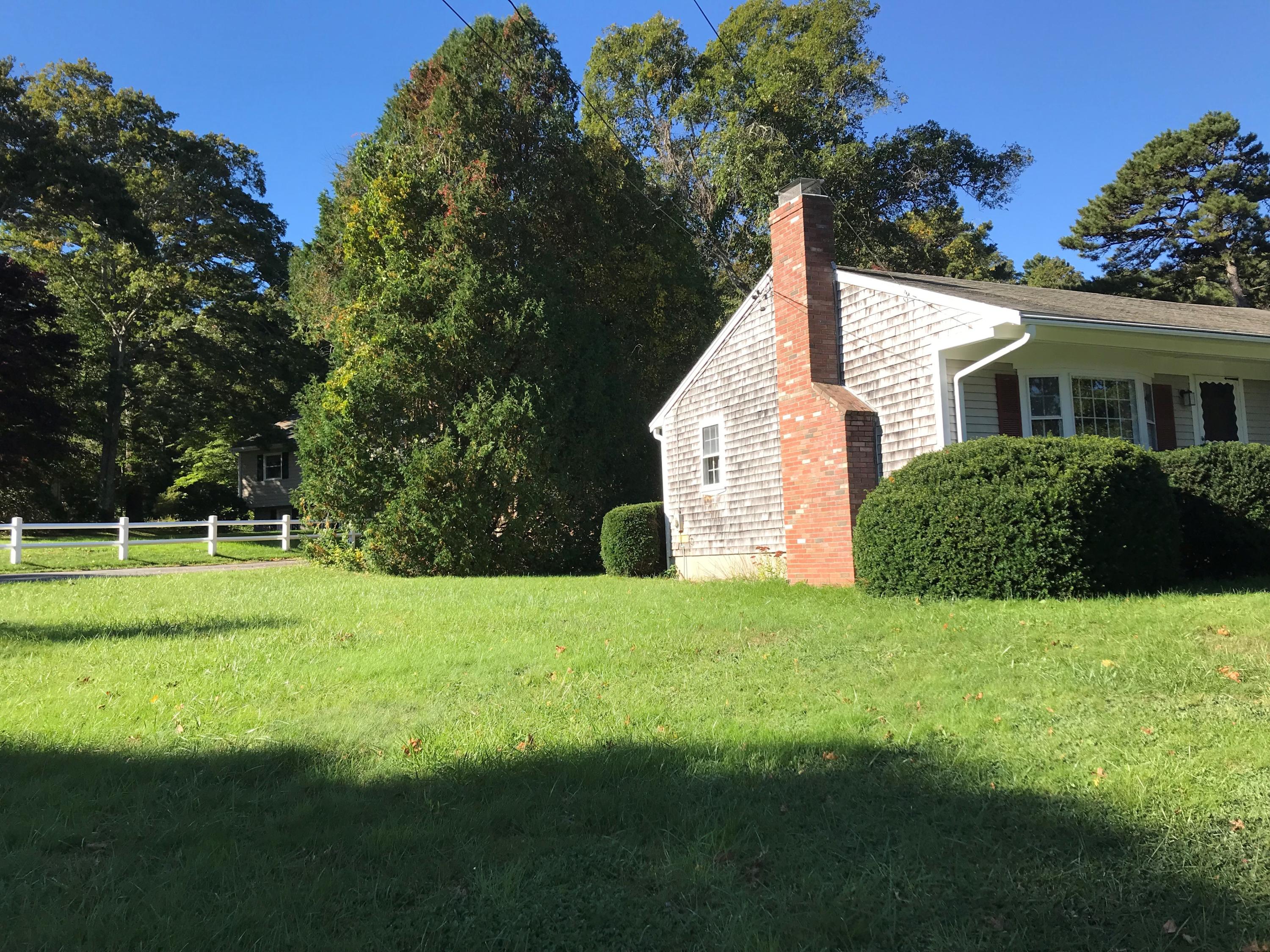 22 Chipman Road Sandwich, MA 02563 - Photo 17 of 18 a view of a house with a yard and potted plants