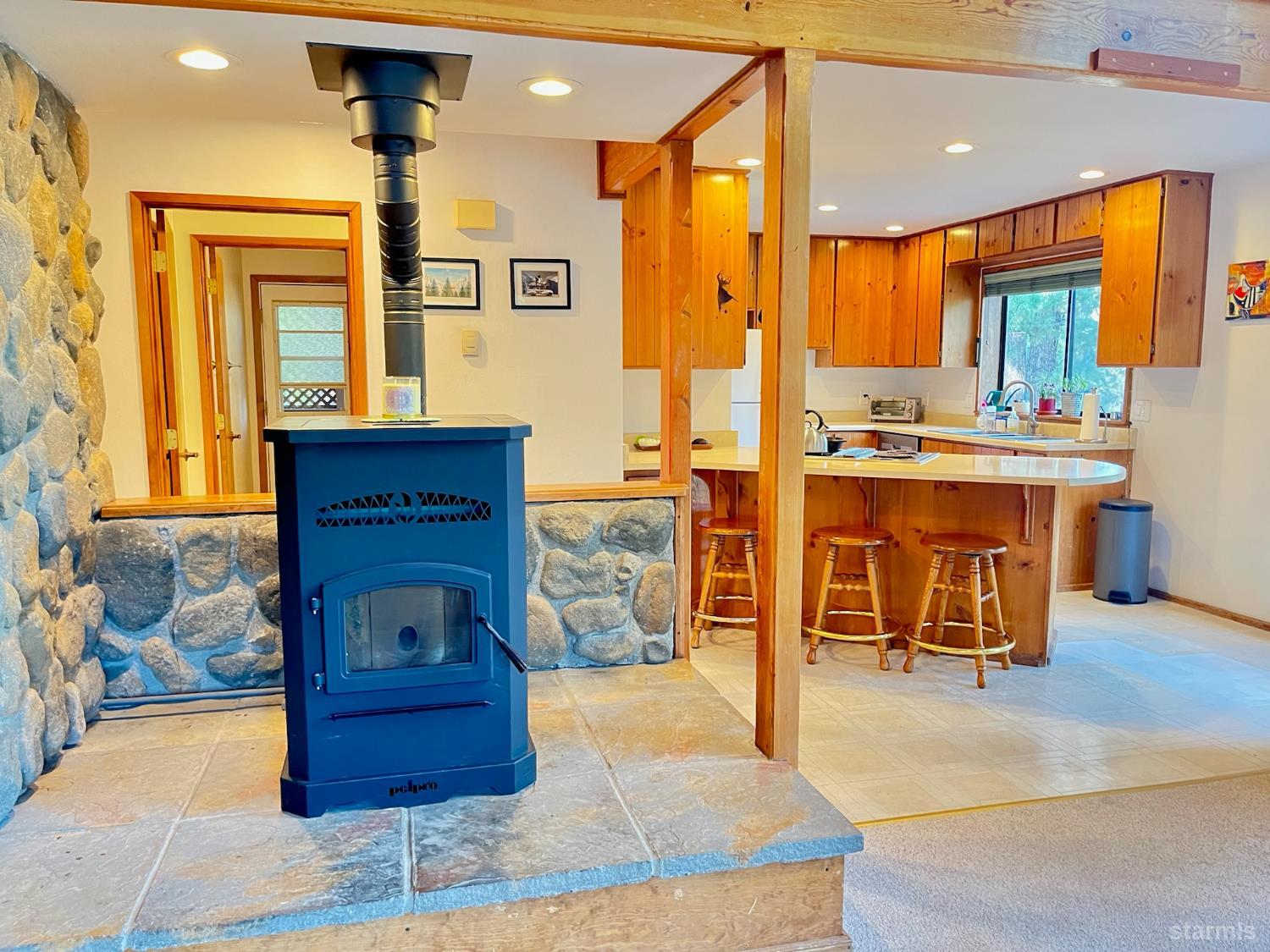 50 Canon View Markleeville, CA 96120 - Photo 7 of 21 a kitchen with stainless steel appliances kitchen island granite countertop a refrigerator a stove and a sink with wooden floors