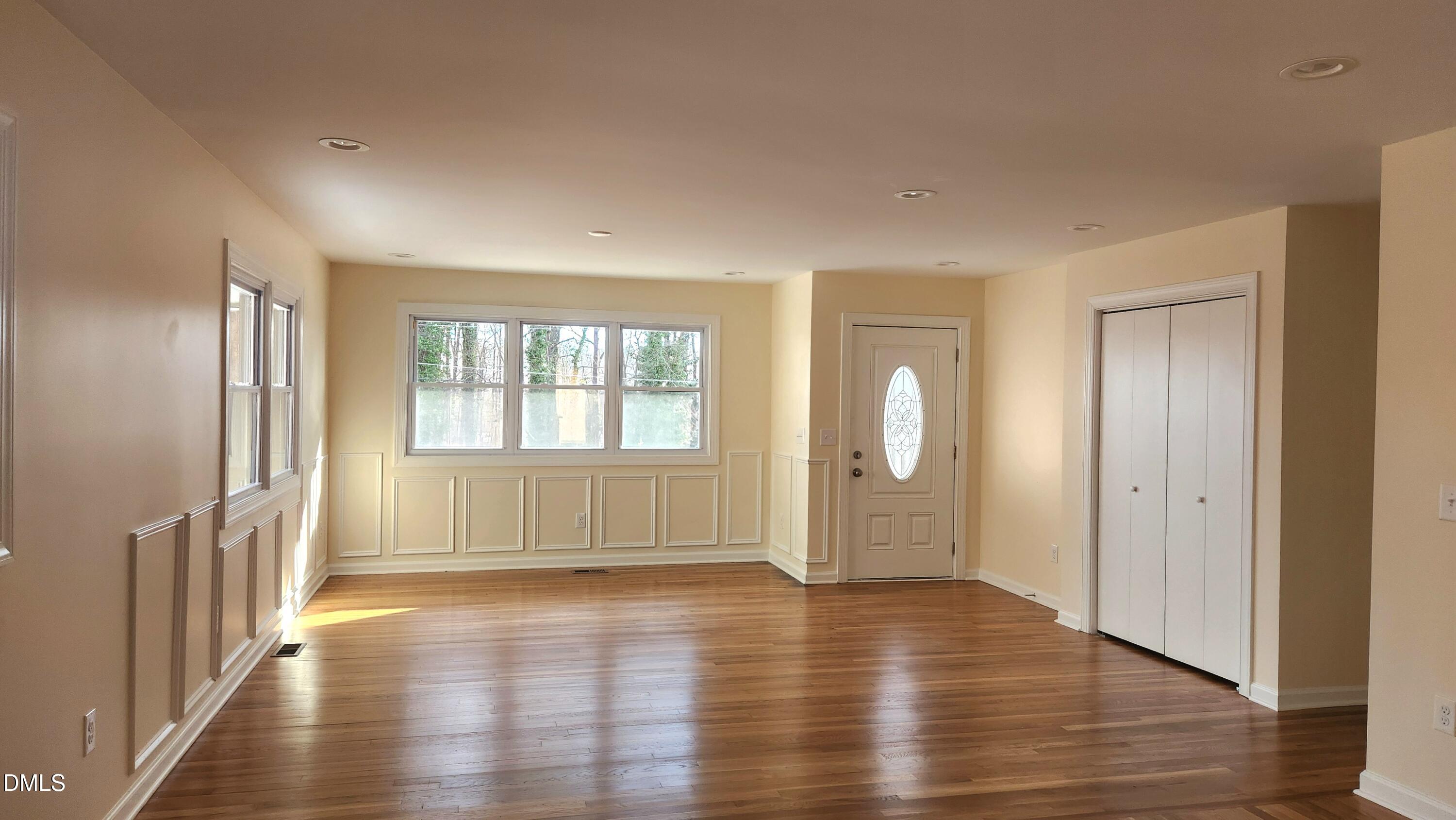 910 Ruby Street Durham, NC 27704 - Photo 4 of 16 an empty room with wooden floor and windows