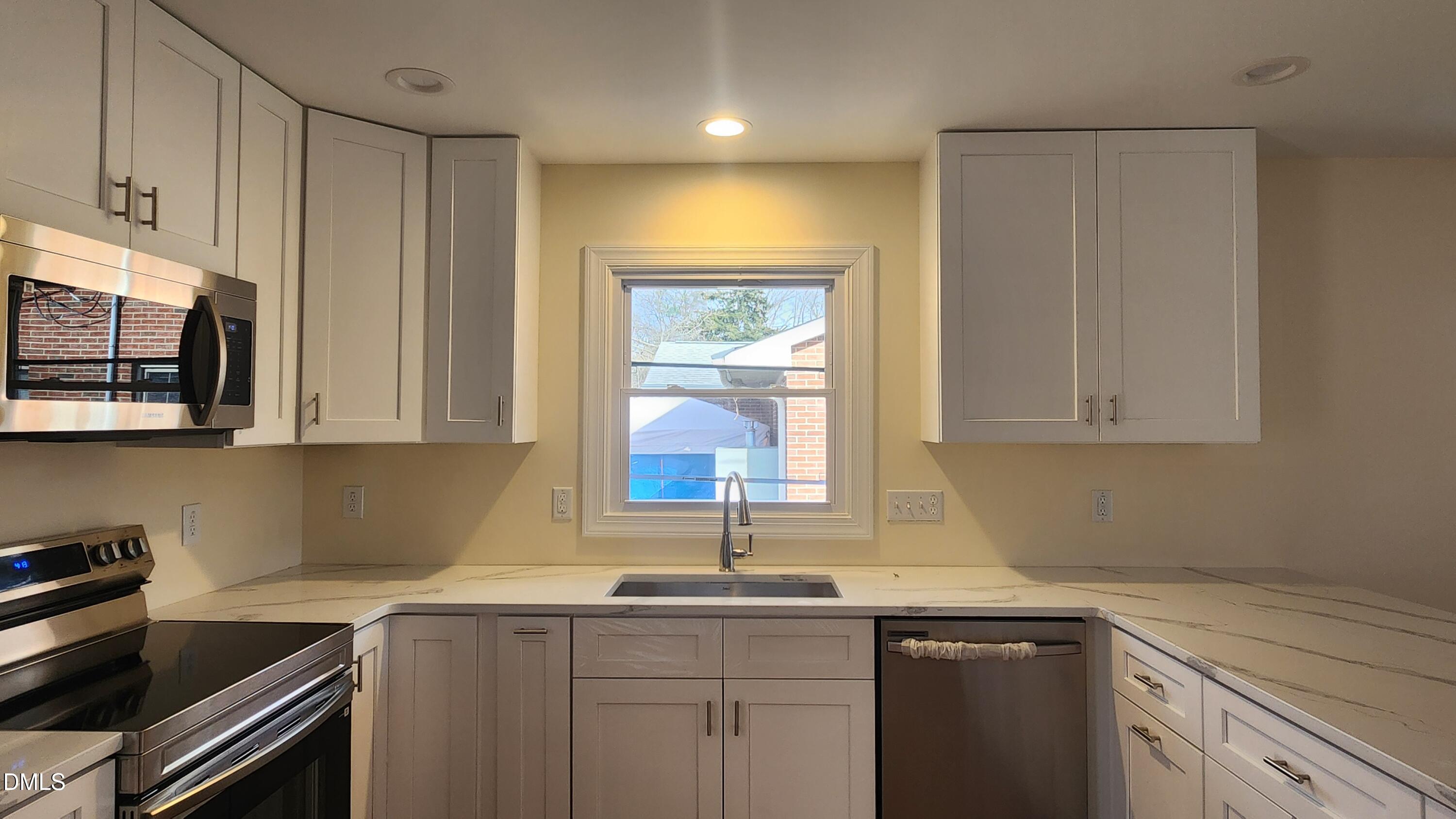 910 Ruby Street Durham, NC 27704 - Photo 5 of 16 a kitchen with a sink cabinets and window