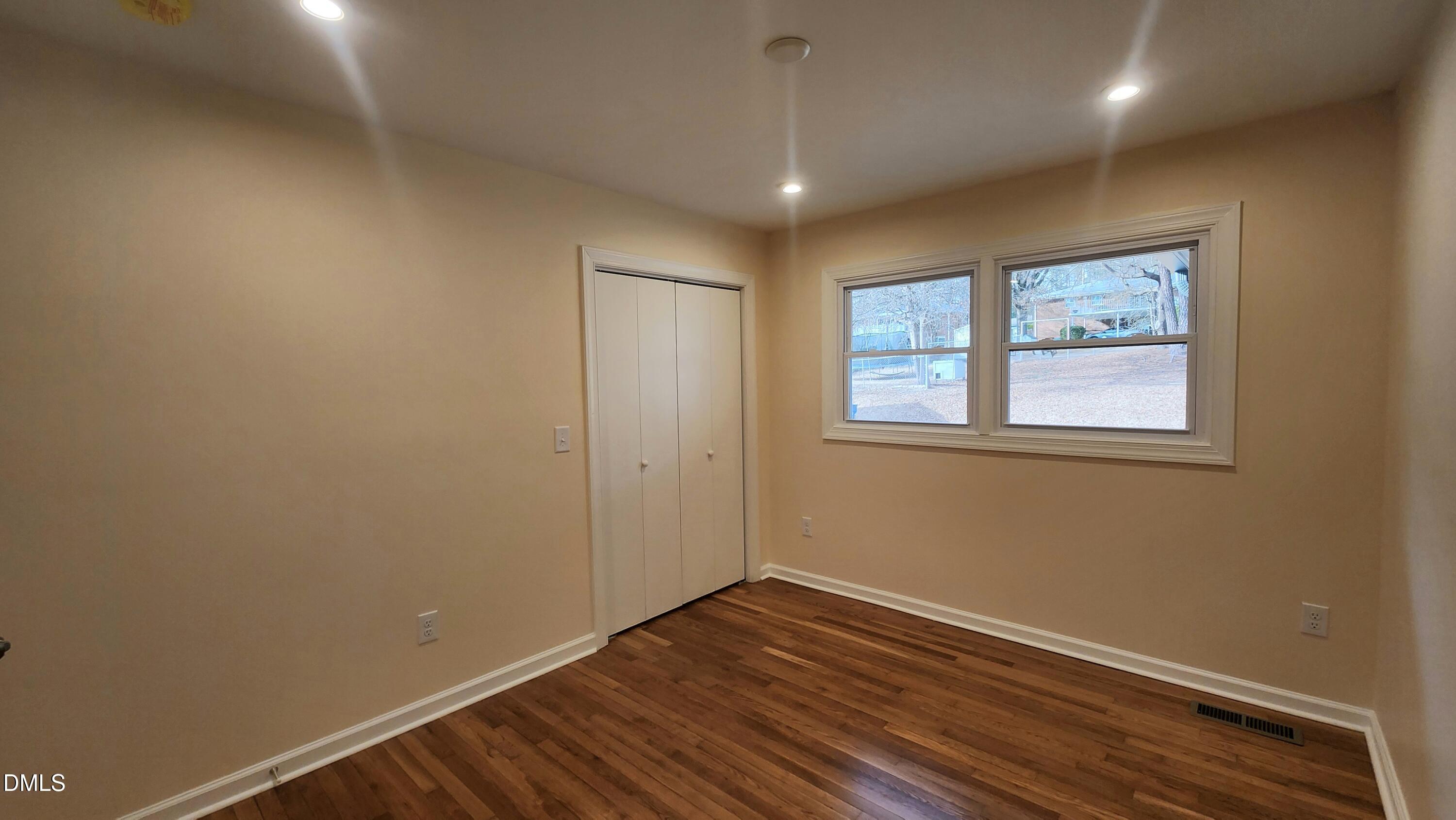 910 Ruby Street Durham, NC 27704 - Photo 9 of 16 a view of an empty room with wooden floor and a window