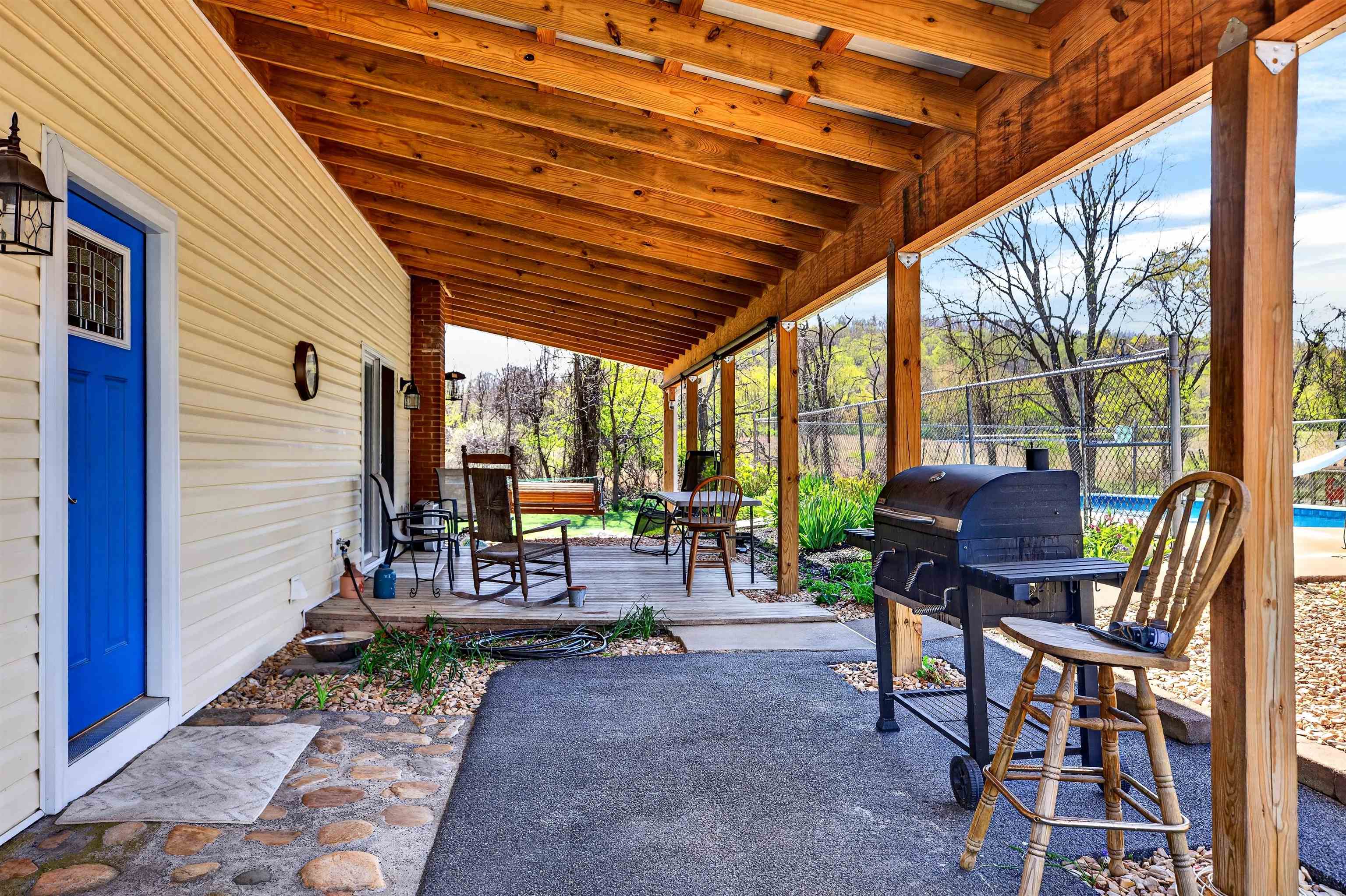 22 Oak Ridge Lane Staunton, VA 24401 - Photo 15 of 62 Main entry (blue door) opens into the eat-in kitchen, home office nook, and open living area. Covered patio offers a welcoming space to relax or entertain.