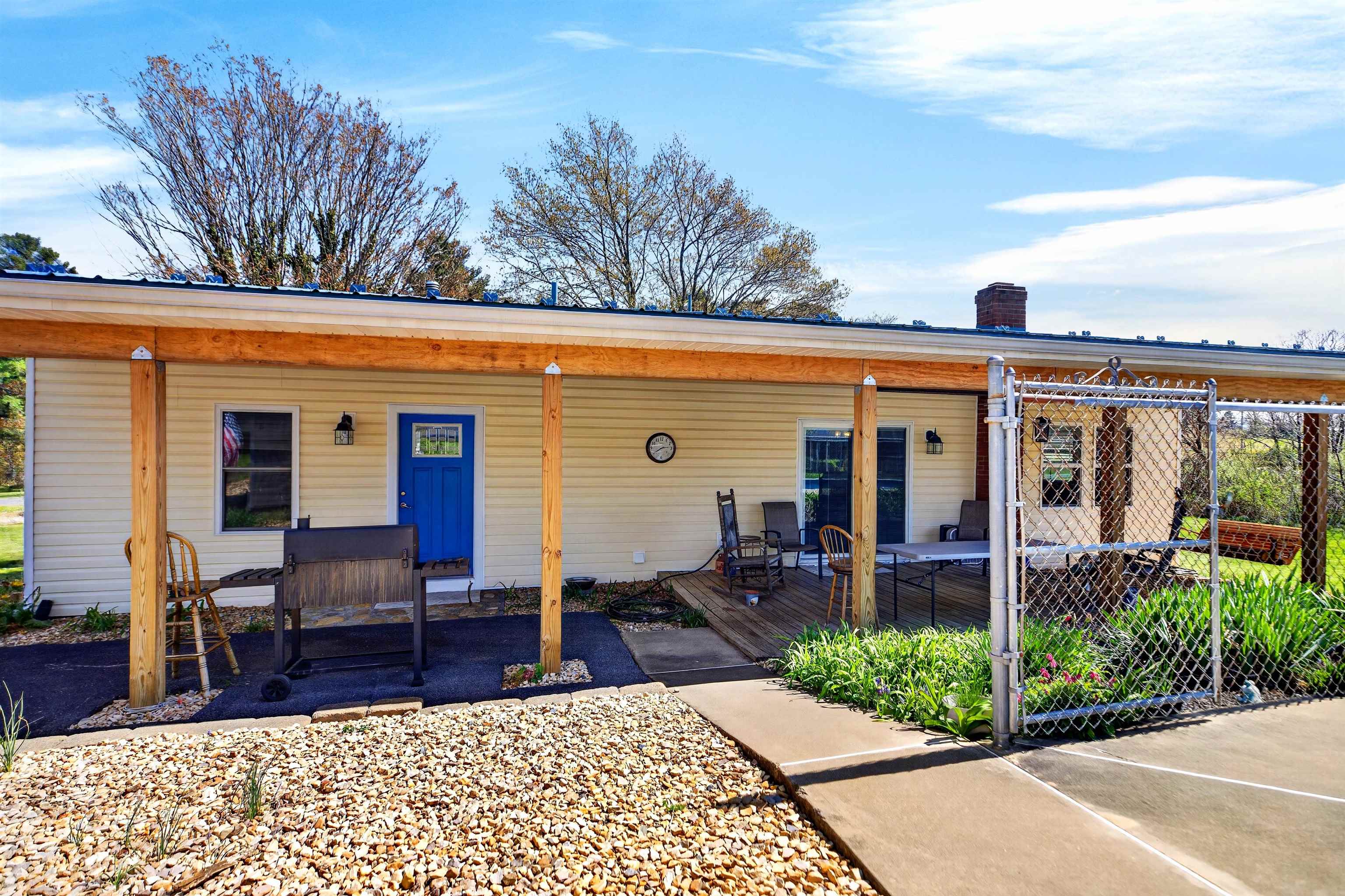 22 Oak Ridge Lane Staunton, VA 24401 - Photo 4 of 62 Spacious covered porch offers a comfortable outdoor living area, perfect for relaxing, enjoying the view, or gathering with family and friends.