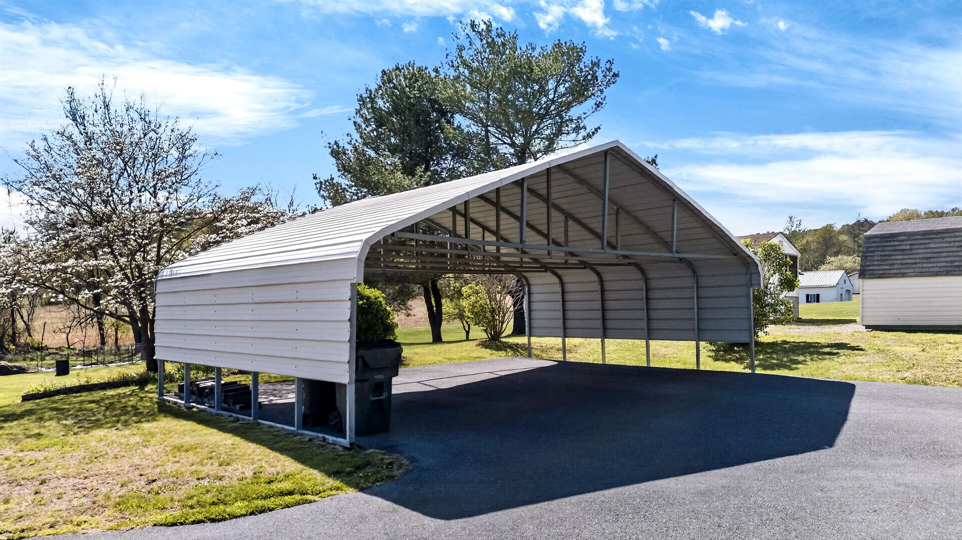 22 Oak Ridge Lane Staunton, VA 24401 - Photo 48 of 62 Approx. 30.3' x 20' metal carport providing covered parking or space for equipment, vehicles, or outdoor storage needs.