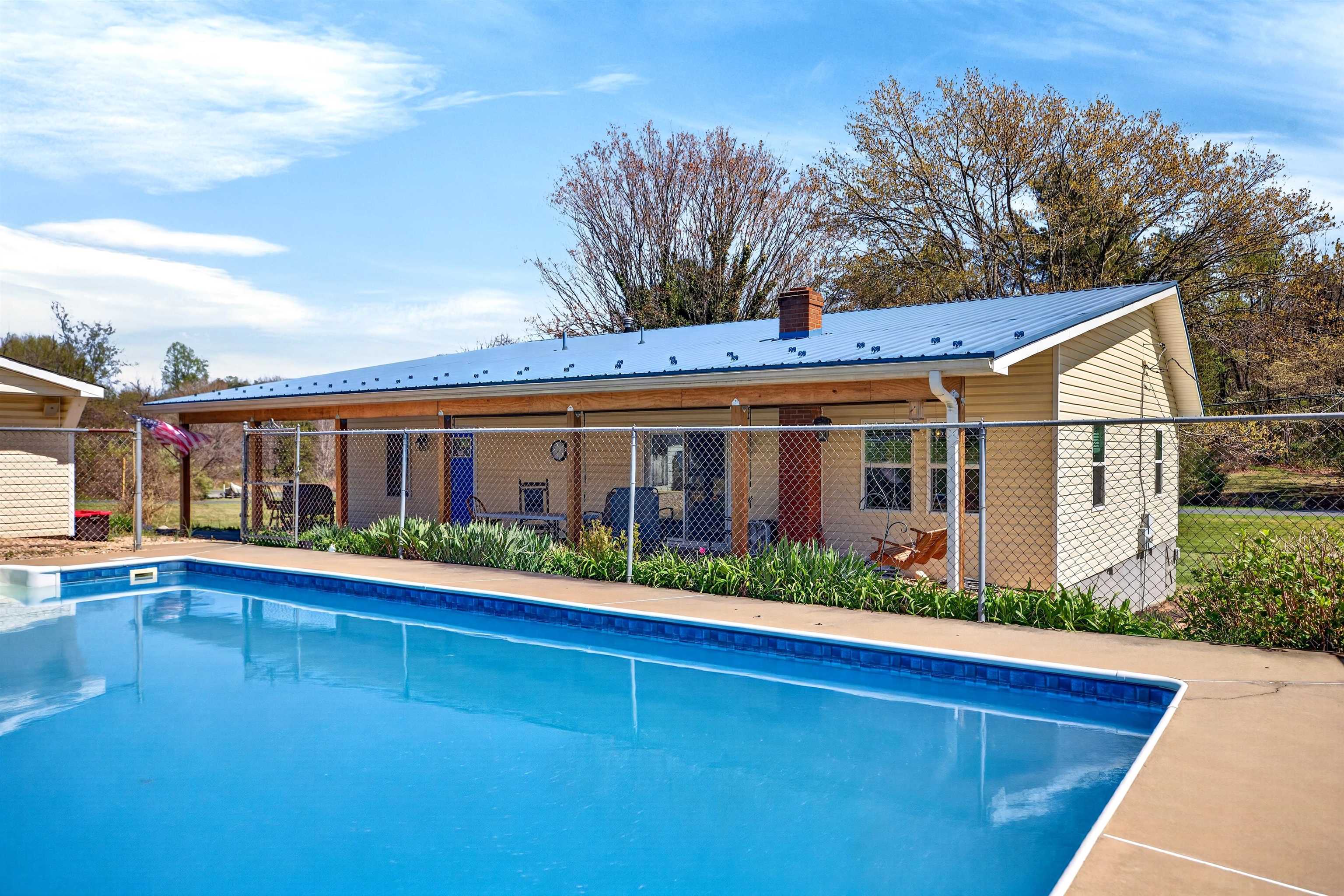 22 Oak Ridge Lane Staunton, VA 24401 - Photo 6 of 62 In-ground pool (approx. 5.5 ft depth) with surrounding patio and fencing — perfect for summer enjoyment, relaxing, and outdoor entertaining.