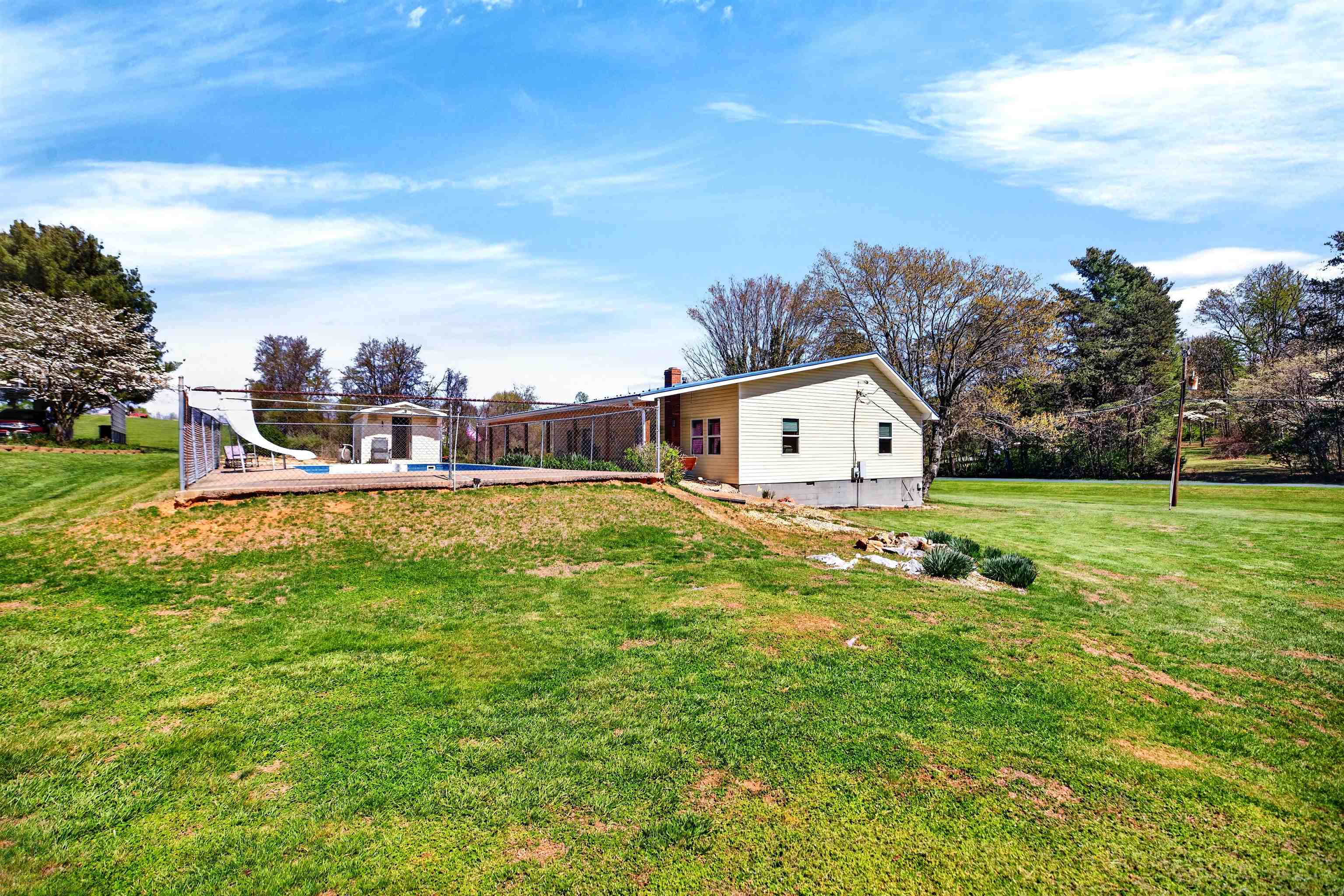 22 Oak Ridge Lane Staunton, VA 24401 - Photo 8 of 62 Expansive, mostly level yard offers plenty of usable space for gardening, outdoor activities, or simply enjoying the peaceful setting.