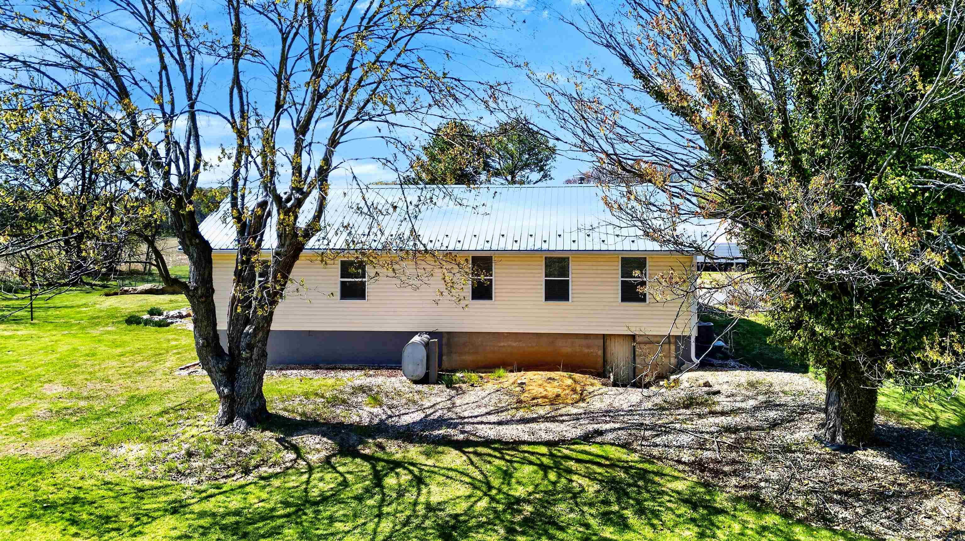22 Oak Ridge Lane Staunton, VA 24401 - Photo 9 of 62 Charming view of the home set among mature trees, offering shade, privacy, and a peaceful outdoor setting.