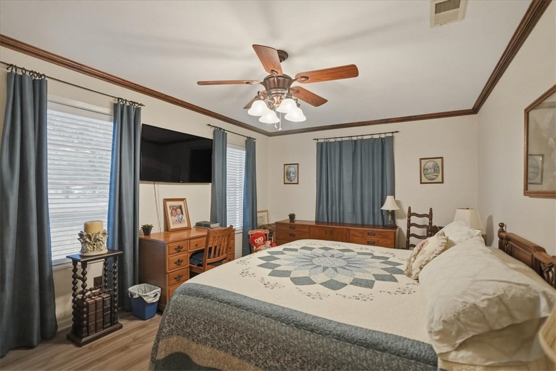 1309 Burleson Street George West, TX 78022 - Photo 15 of 32 a bedroom with a bed and a flat tv screen on dresser