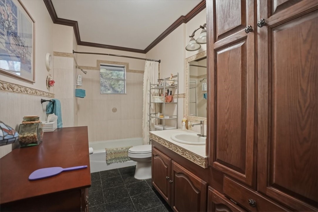 1309 Burleson Street George West, TX 78022 - Photo 17 of 32 a bathroom with a sink a toilet and shower