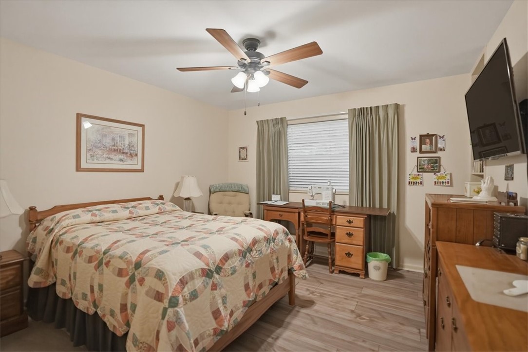 1309 Burleson Street George West, TX 78022 - Photo 19 of 32 a bedroom with a bed and a flat screen tv