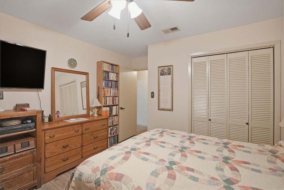 1309 Burleson Street George West, TX 78022 - Photo 20 of 32 a bedroom with a bed and a flat screen tv