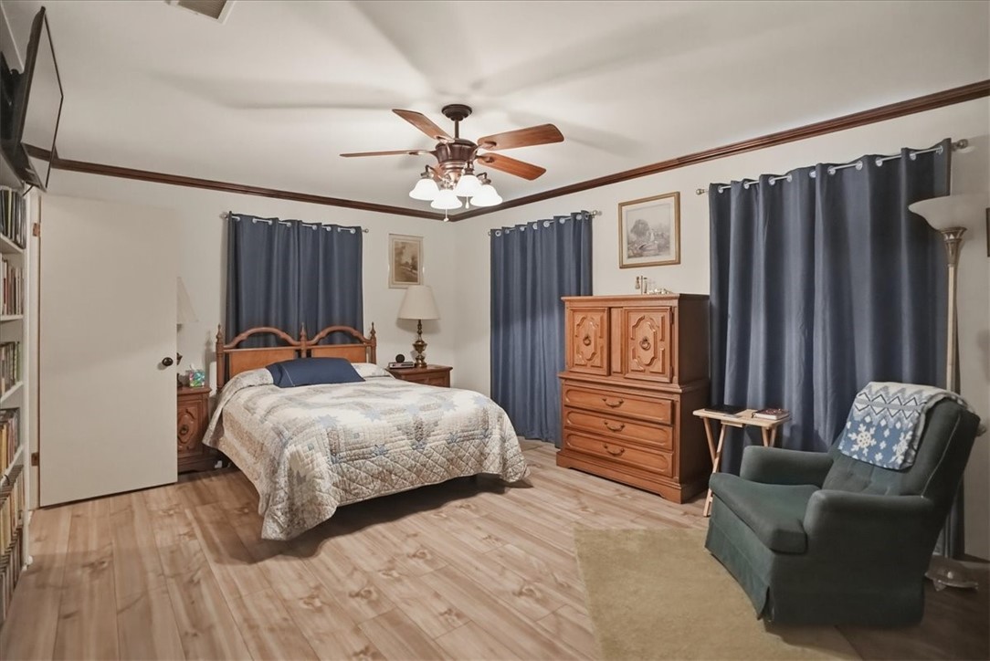 1309 Burleson Street George West, TX 78022 - Photo 21 of 32 a bedroom with a bed couch and a window
