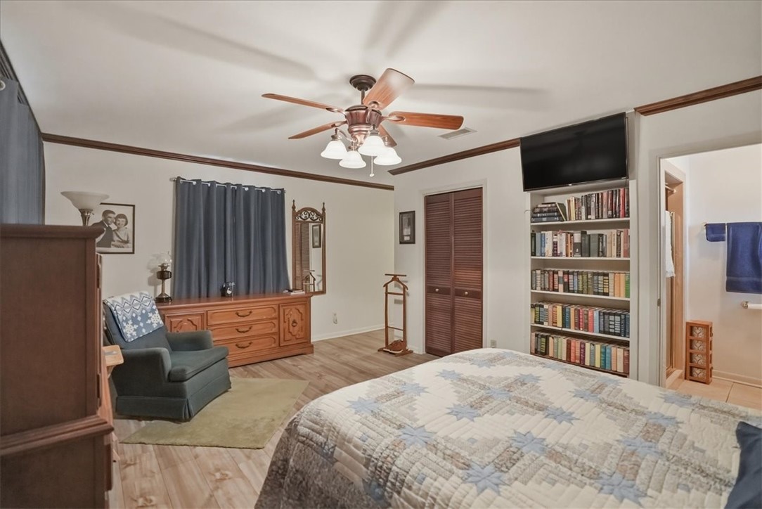 1309 Burleson Street George West, TX 78022 - Photo 22 of 32 a spacious bedroom with a bed and a flat screen tv