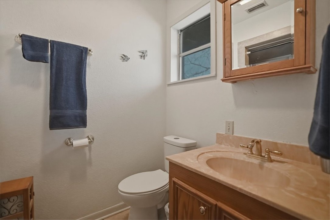 1309 Burleson Street George West, TX 78022 - Photo 24 of 32 a bathroom with a sink and a toilet