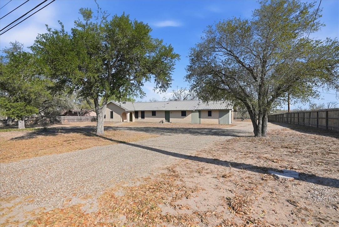 1309 Burleson Street George West, TX 78022 - Photo 27 of 32 a front view of a house with a yard covered with snow