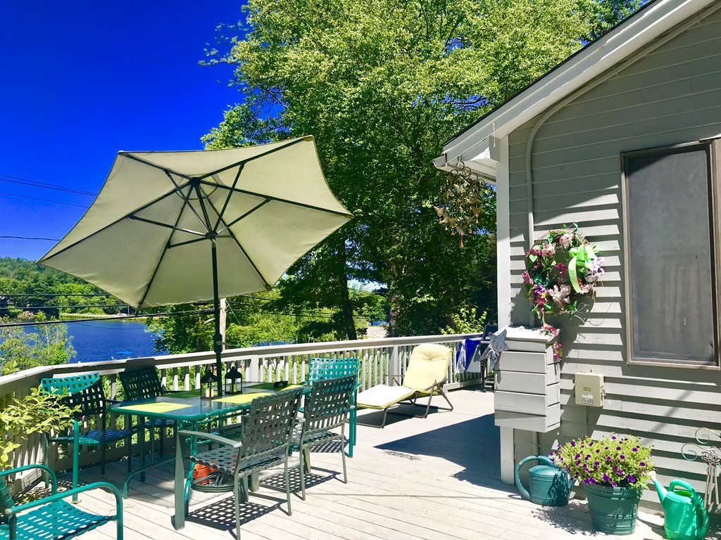 263 Mashapaug Road Holland, MA 01521 - Photo 8 of 25 a view of balcony with wooden floor and outdoor seating