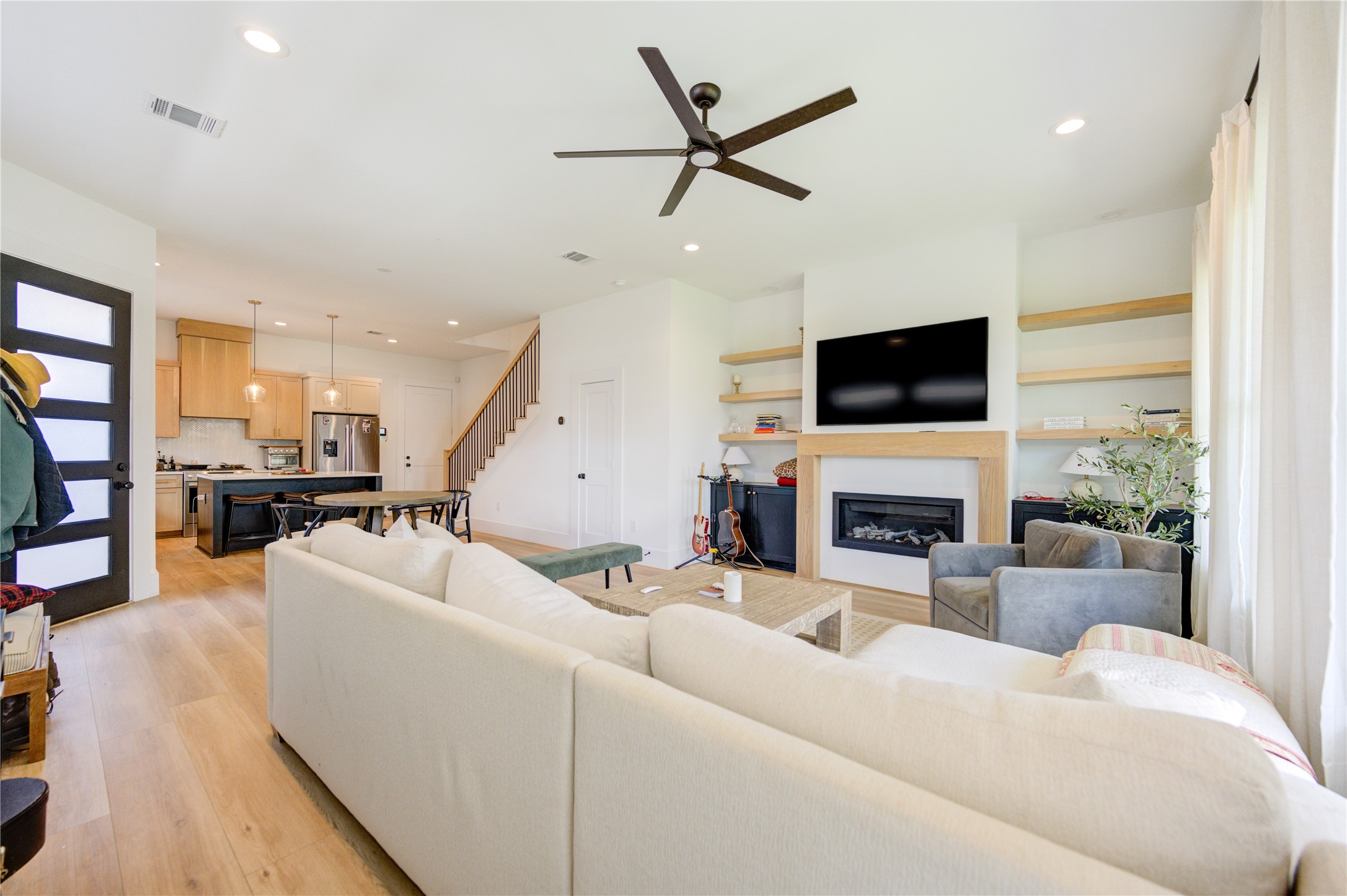 18 Sidney Street, Unit A Houston, TX 77003 - Photo 4 of 30 a living room with furniture a fireplace and a flat screen tv