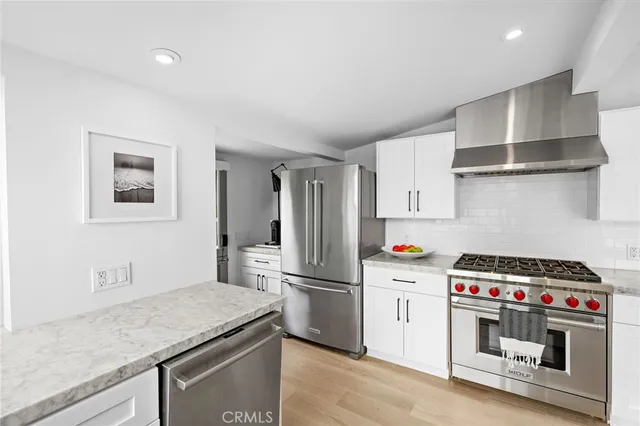 a view of a patio with table and chairs under an umbrella
