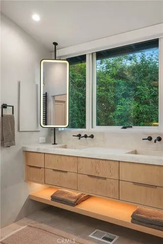 a front view of a house with potted plants
