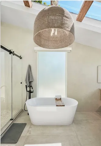 a backyard of a house with table and chairs under an umbrella