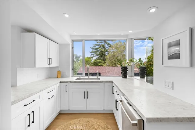 a kitchen with a stove a sink and a refrigerator